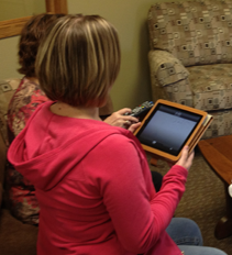 Woman on phone using computer.